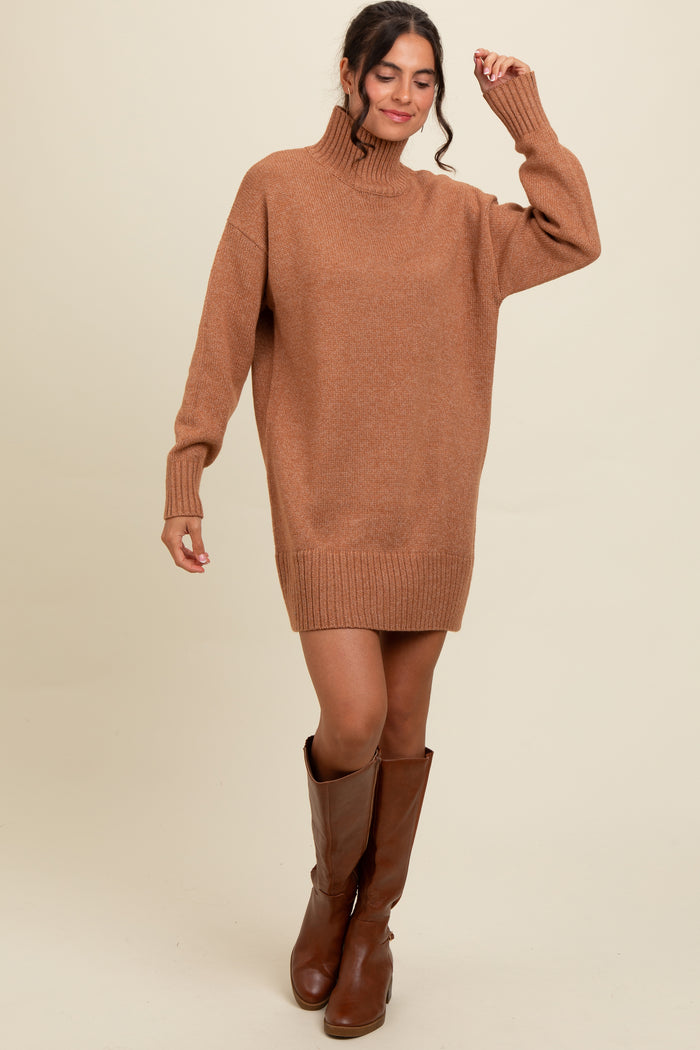 woman wearing a cozy brown oversized sweater dress with a high neck and long sleeves, paired with brown knee-high boots