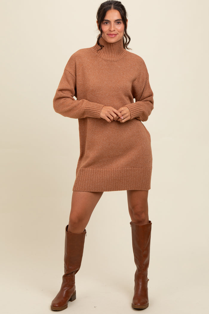 woman wearing a brown knitted turtleneck sweater dress with long sleeves and knee-high brown boots