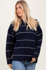 woman wearing a navy blue striped oversized sweater with a relaxed fit and long sleeves