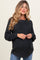 woman wearing a dark gray knitted maternity sweater with a round neckline and relaxed fit, showing her baby bump