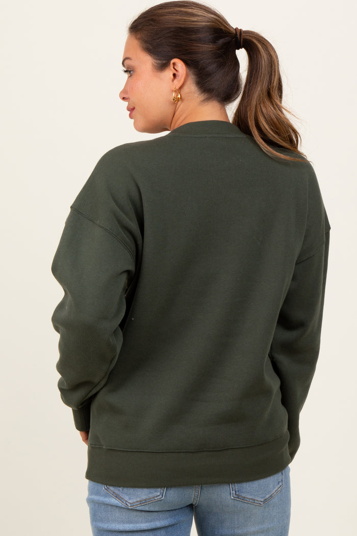 woman wearing a dark green oversized maternity sweatshirt, shown from the back with a relaxed fit