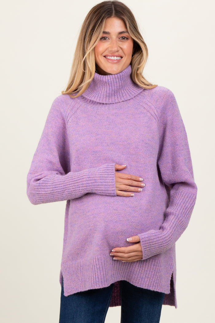 woman wearing a lavender turtleneck maternity sweater and cradling her baby bump