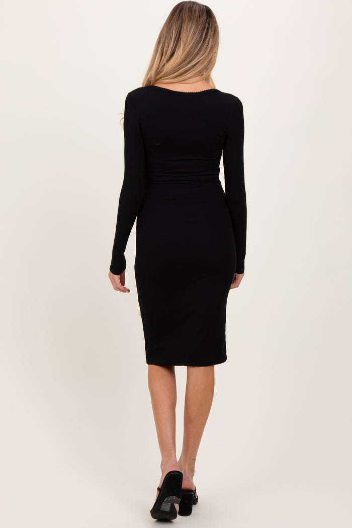 woman wearing a black long sleeve fitted maternity dress, showing a smooth silhouette from the back