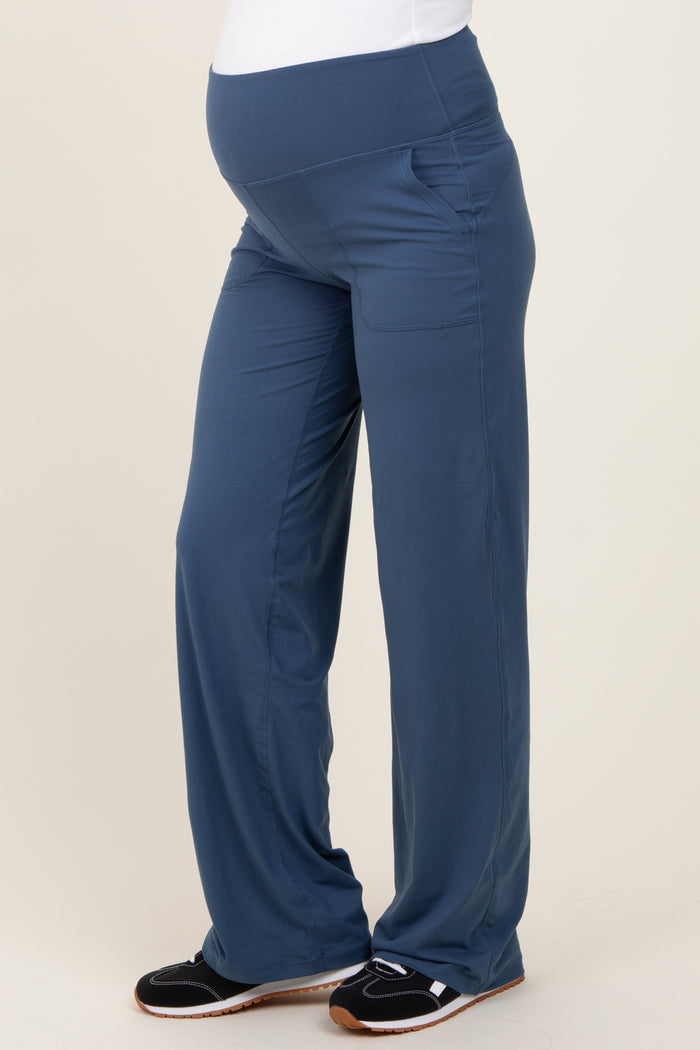 woman wearing navy blue maternity jogger pants with side pockets and a comfortable waistband, showing her baby bump