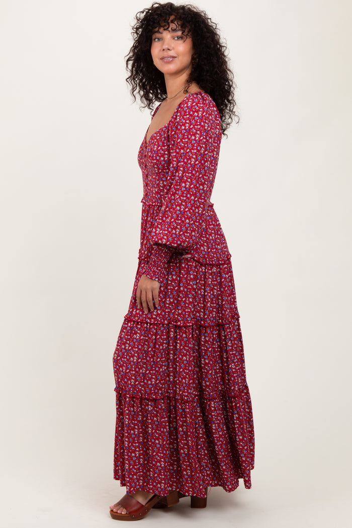 woman wearing a red floral maxi dress with tiered ruffles and long sleeves