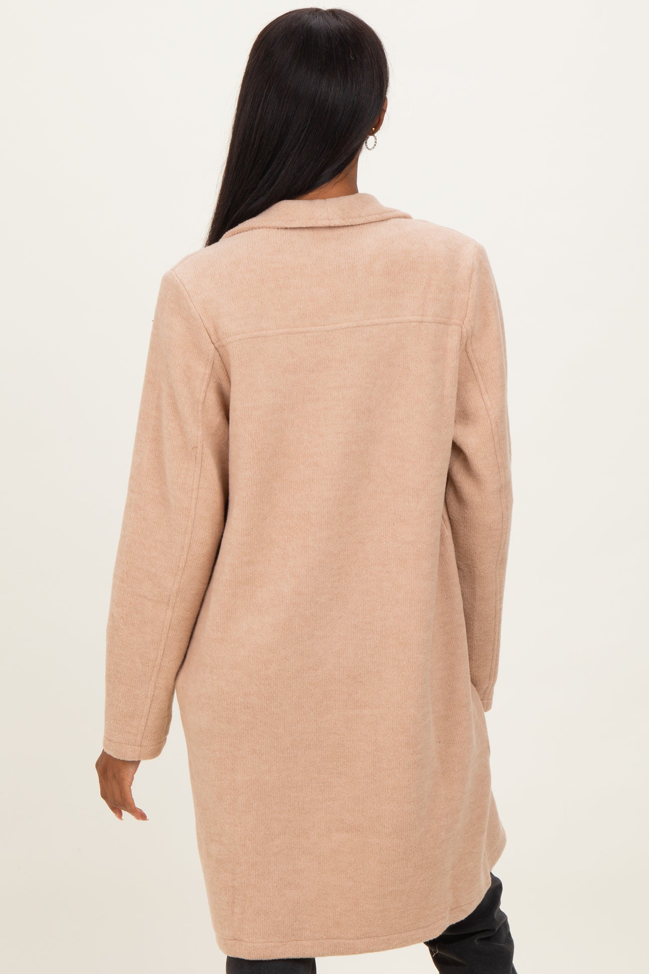woman wearing a beige long wool blend coat with a relaxed fit viewed from the back