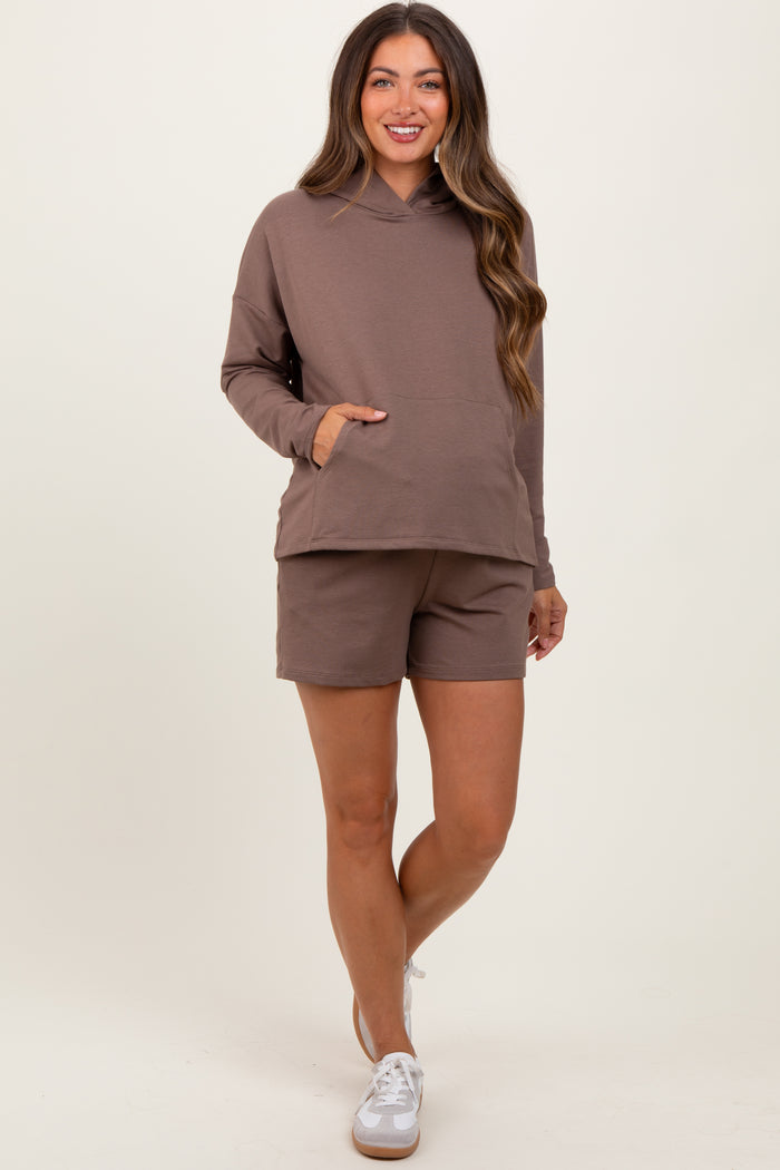woman wearing a brown maternity hoodie with a front pocket and matching shorts