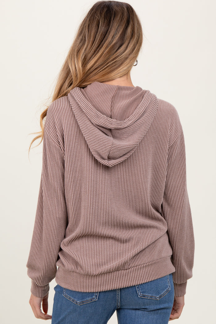 woman wearing a mauve ribbed maternity hoodie with a hood and long sleeves, showing the back view