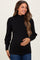 woman wearing a black ribbed maternity top with puff sleeves and holding her baby bump