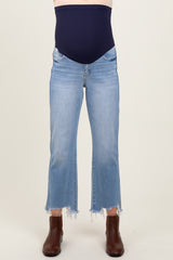 woman wearing light wash maternity jeans with a frayed hem and a navy stretchy maternity panel