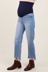 woman wearing a navy blue maternity belly support jeans with distressed hem and a visible baby bump