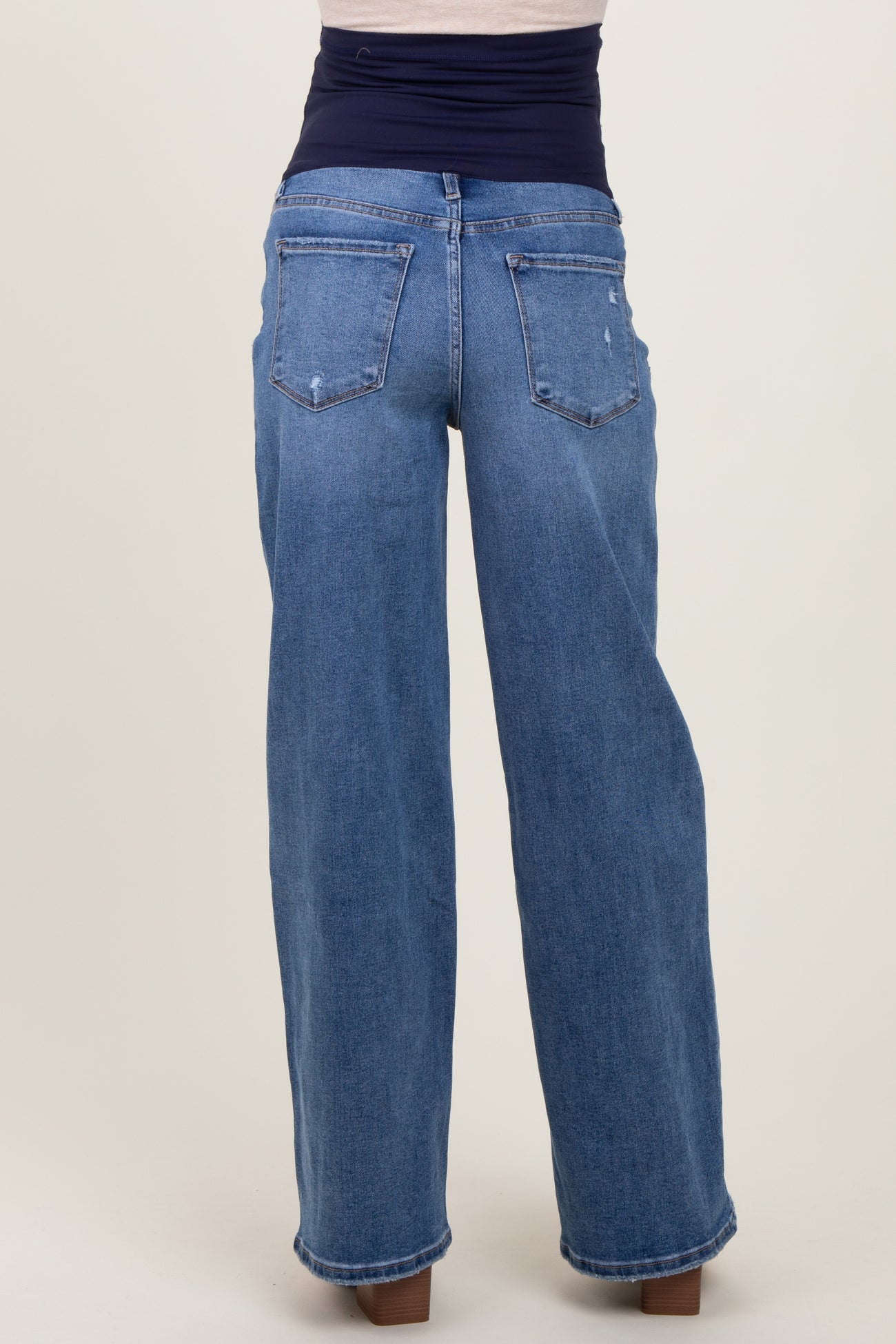 maternity wear wide leg blue jeans with a dark waistband, viewed from the back