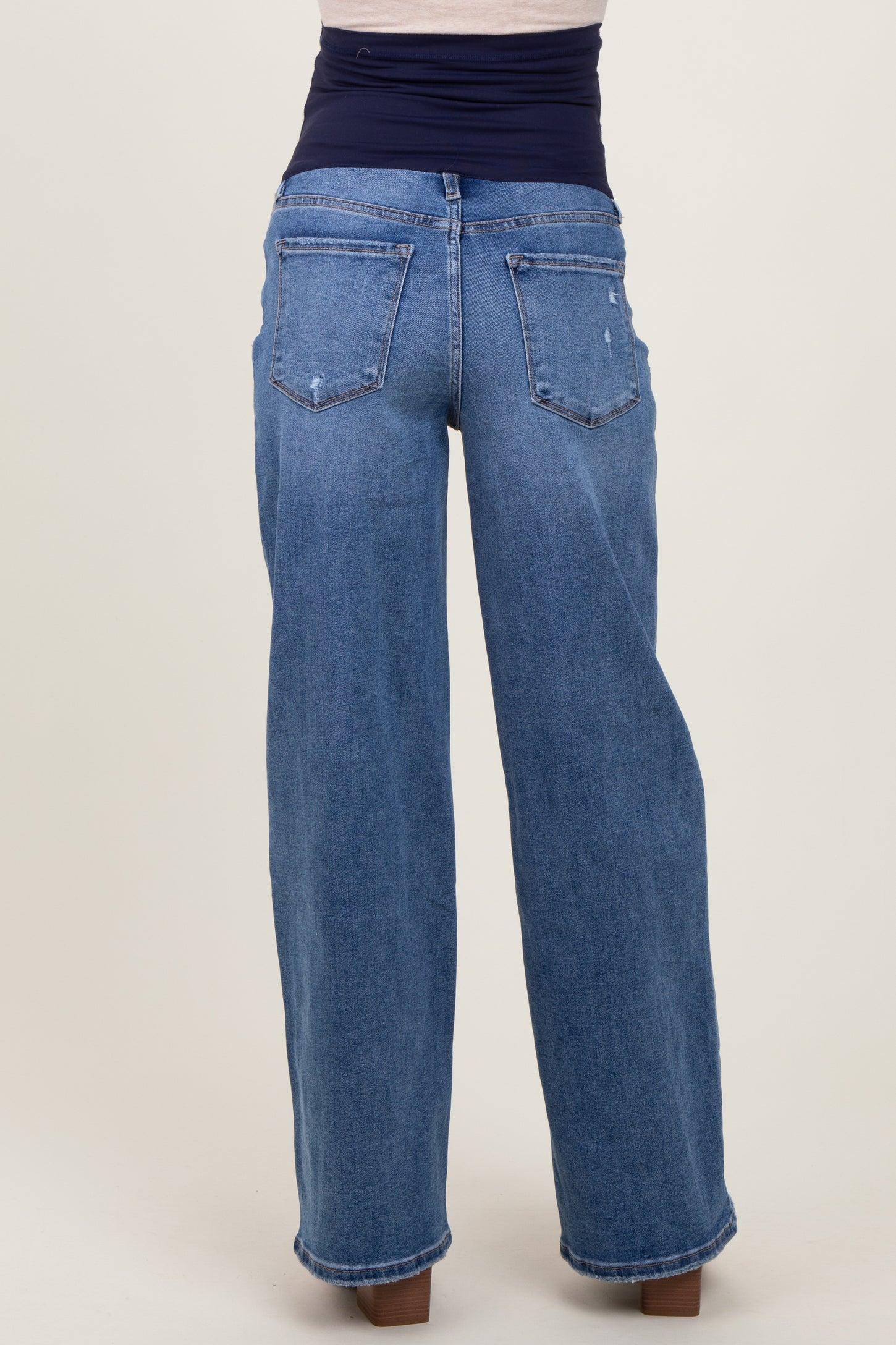 maternity wear wide leg blue jeans with a dark waistband, viewed from the back