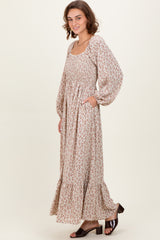 woman wearing a floral long sleeve maxi dress with a square neckline and pockets
