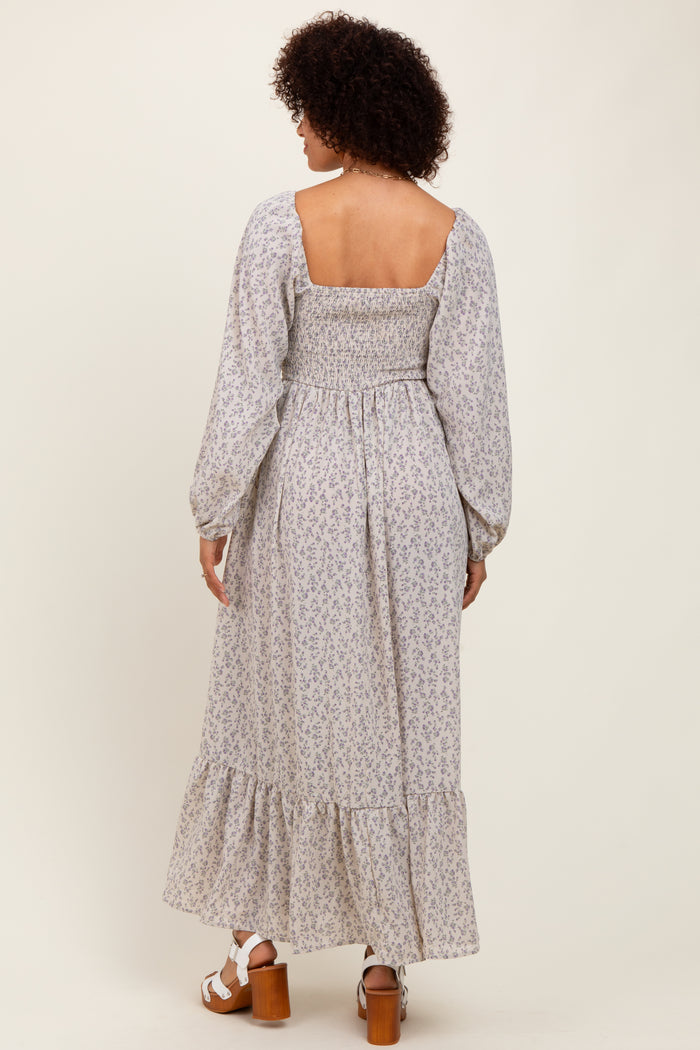woman wearing a pastel floral maxi dress with a smocked back and long puff sleeves