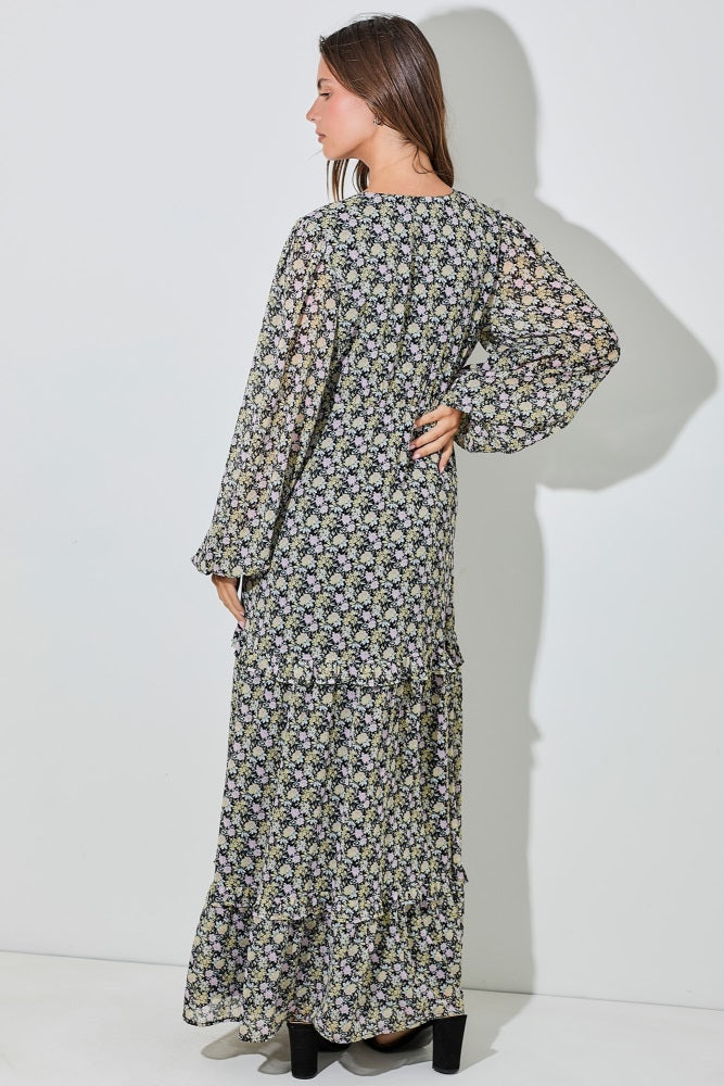 woman wearing a floral print long sleeve maxi dress with tiered ruffles, shown from the back