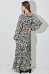 woman wearing a floral print long sleeve maxi dress with tiered ruffles, shown from the back