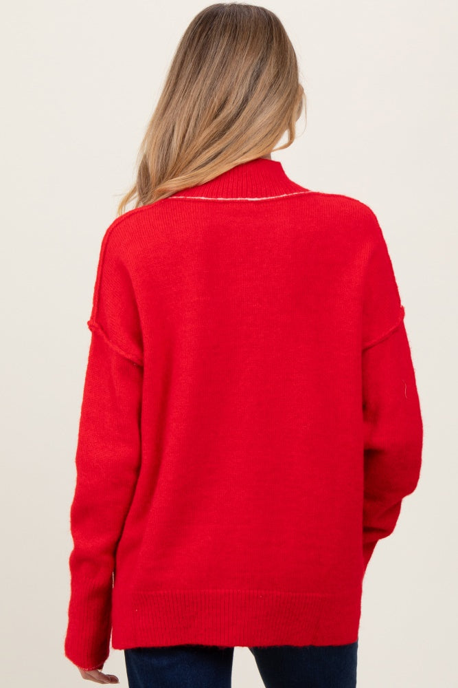 woman wearing a red oversized maternity sweater, shown from the back with long sleeves and a relaxed fit