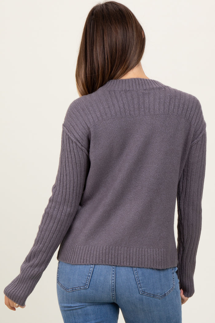 woman wearing a grey maternity sweater with ribbed detailing and a relaxed fit, showing her back