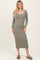 woman wearing a long sleeve olive green ribbed midi dress and brown sandals