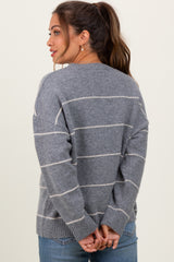 woman wearing a gray striped maternity sweater with a relaxed fit and long sleeves, seen from the back
