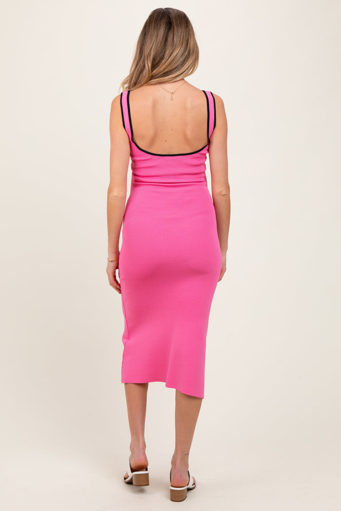 woman wearing a hot pink maternity dress with a fitted silhouette and spaghetti straps, showing her back