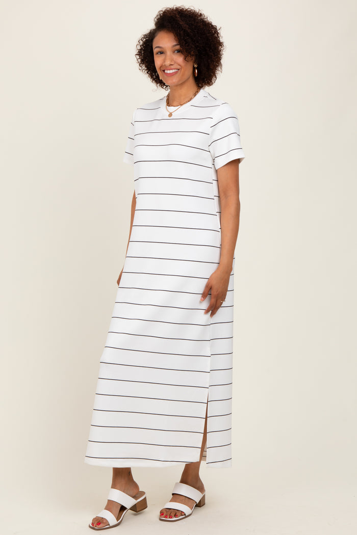 woman wearing a white striped maxi dress with short sleeves and side slits, styled with white sandals
