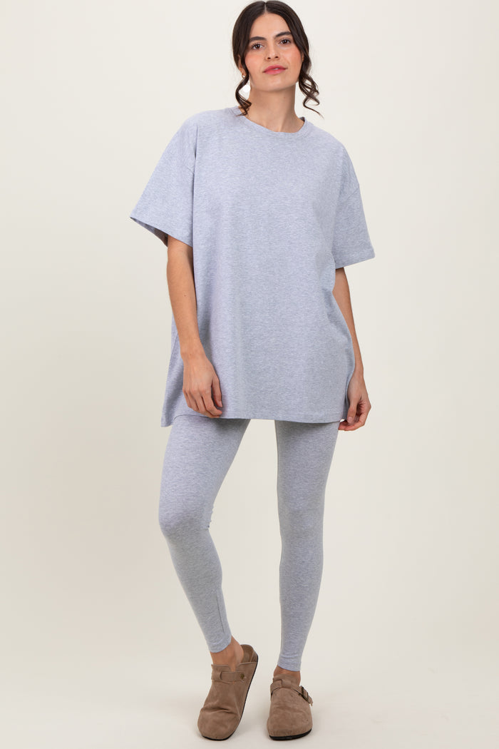 woman wearing a gray oversized t-shirt and matching leggings with brown slip-on shoes