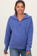 woman wearing a purple oversized maternity sweater with a half-zip collar and relaxed fit, showcasing her baby bump