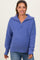 woman wearing a purple oversized maternity sweater with a half-zip collar and relaxed fit, showcasing her baby bump