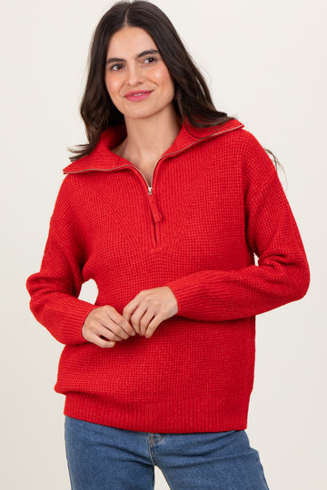 woman wearing a red half-zip sweater with a textured knit design and long sleeves