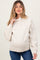 woman wearing a cream maternity hoodie with a relaxed fit and drawstring hood, showcasing a visible baby bump