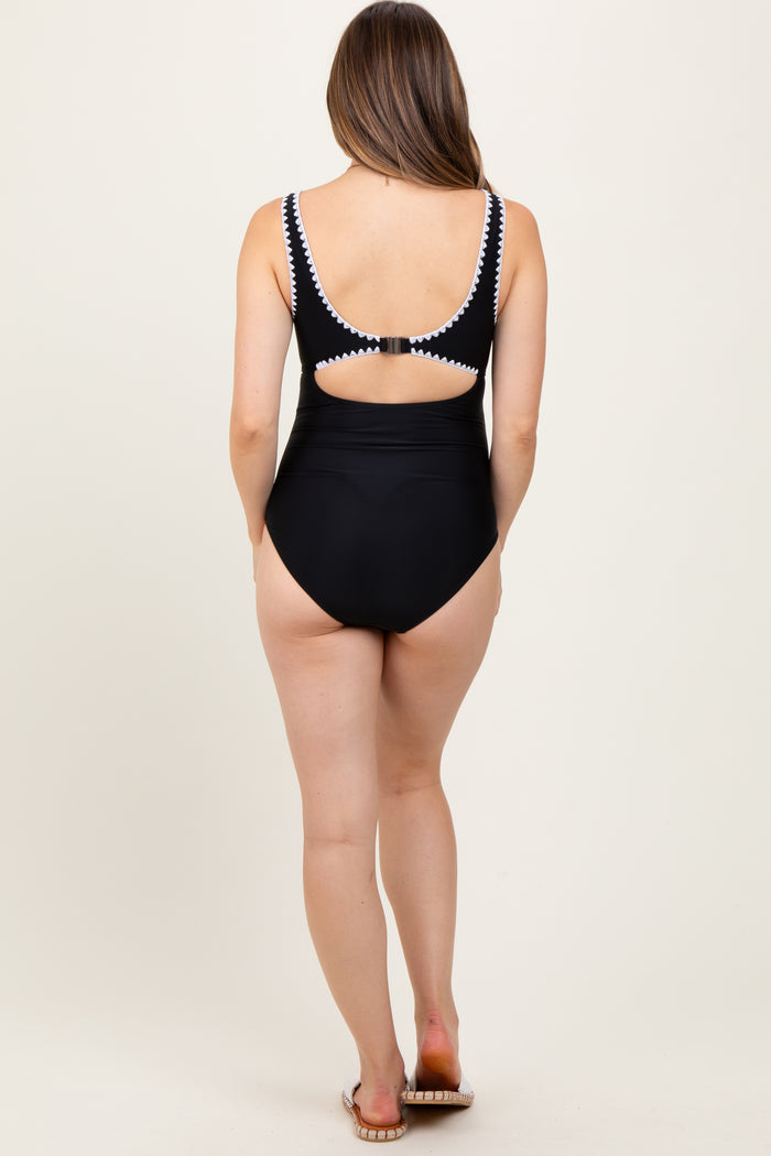maternity wear black one-piece swimsuit with cut-out back detail, model seen from behind