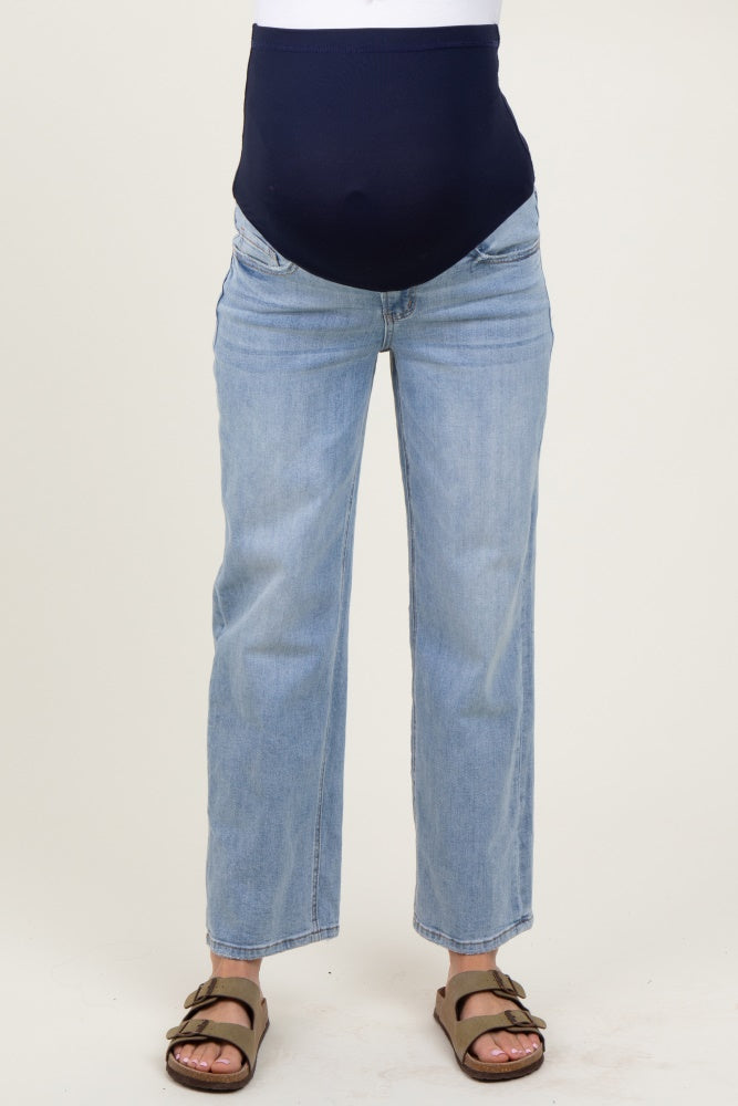 woman wearing light blue maternity jeans with a dark blue over-the-bump band
