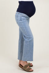 woman wearing light blue maternity flared jeans with a navy blue supportive waistband and visible baby bump