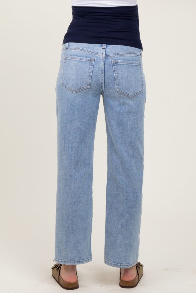woman wearing light blue maternity jeans, showing the back and wide leg style