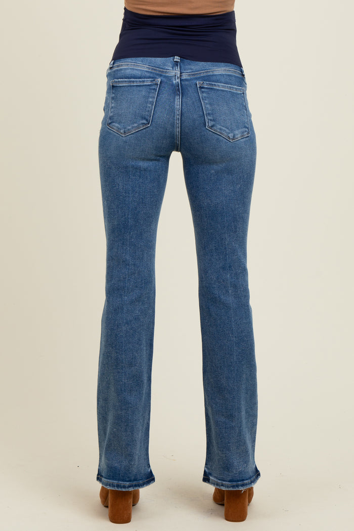 maternity wear light blue flared jeans shown from the back on a model with a fitted dark top