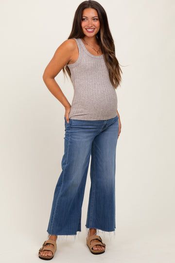 woman wearing a gray ribbed maternity tank top and wide-leg jeans, showing her baby bump