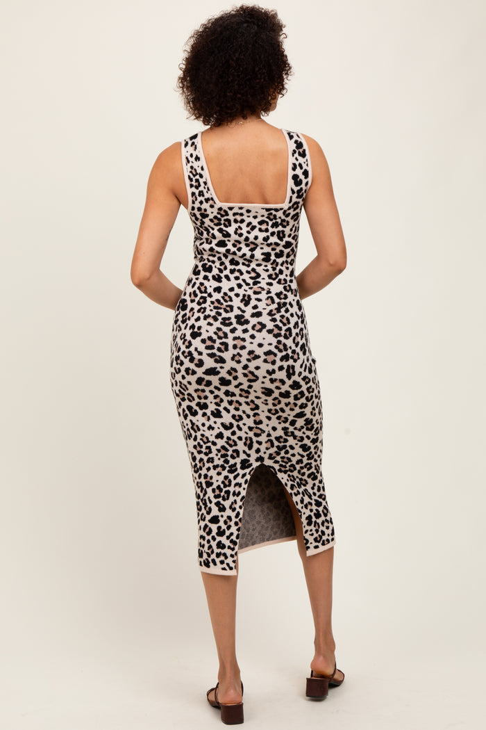 woman wearing a leopard print midi dress with a back slit and fitted silhouette