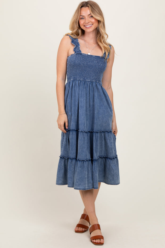 woman wearing a denim blue tiered maxi dress with ruffled straps and a smocked bodice