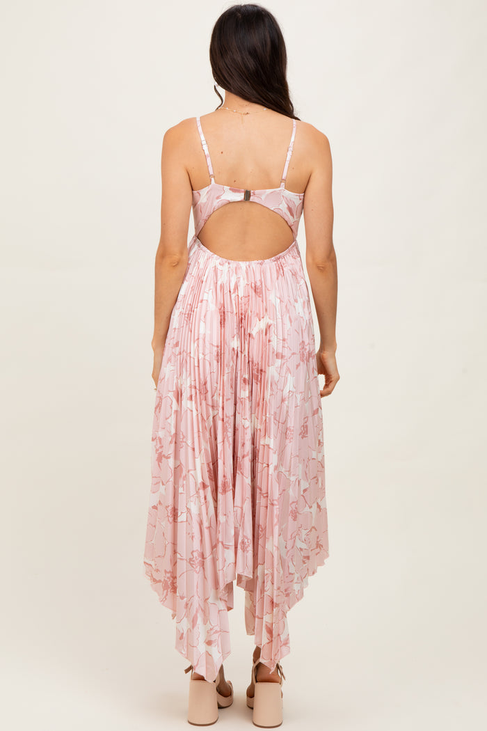 woman wearing a pink floral maxi dress with a high-low hem and open back detail