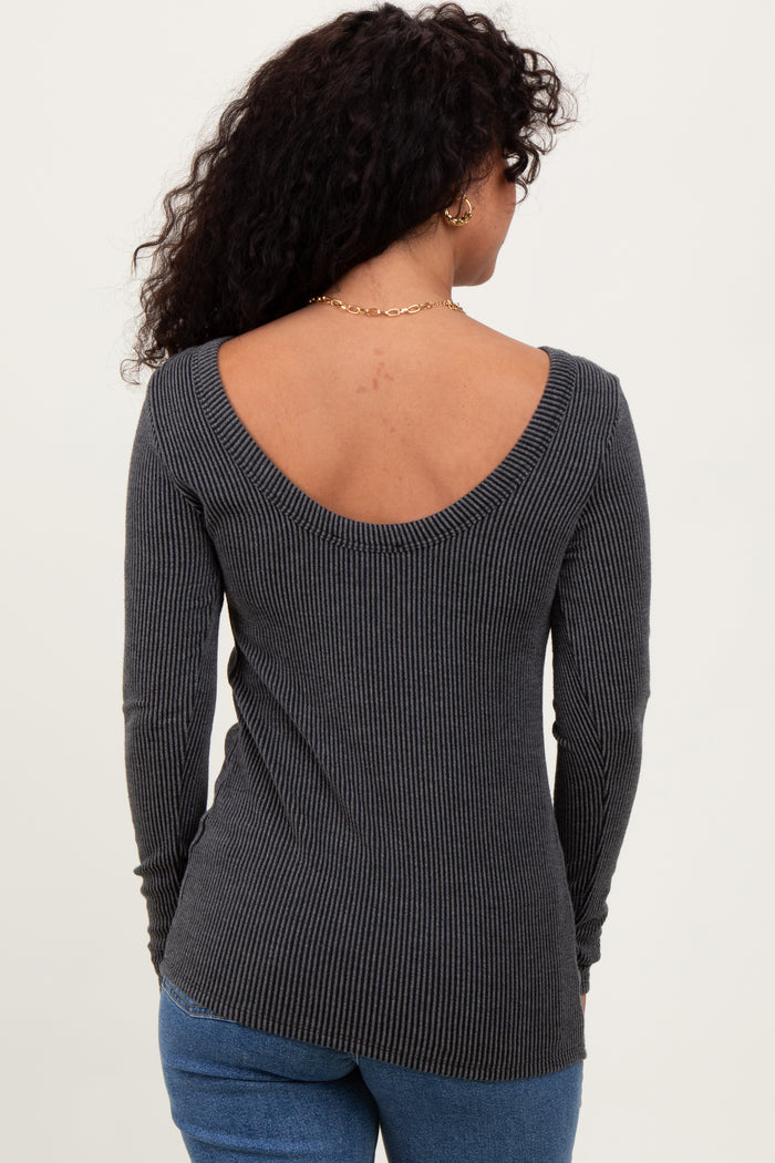 woman wearing a gray ribbed top with a low back and long sleeves, shown from the back
