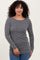woman wearing a grey ribbed long sleeve top with a boat neckline and straight fit, standing smiling