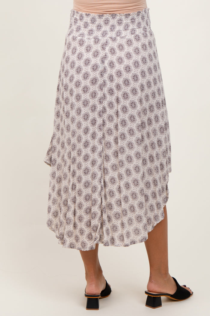 woman wearing a printed asymmetrical maternity skirt with a flowy design and a comfortable waistband