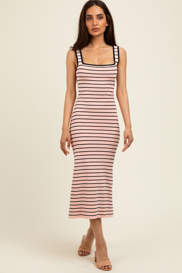 woman wearing a pink and black striped midi dress with a square neckline and fitted style