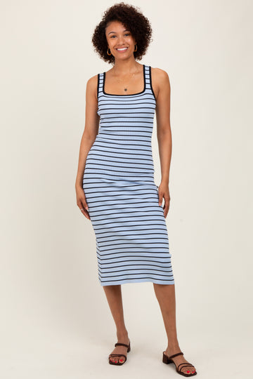 woman wearing a light blue and navy striped midi dress with a scoop neckline and slim fit
