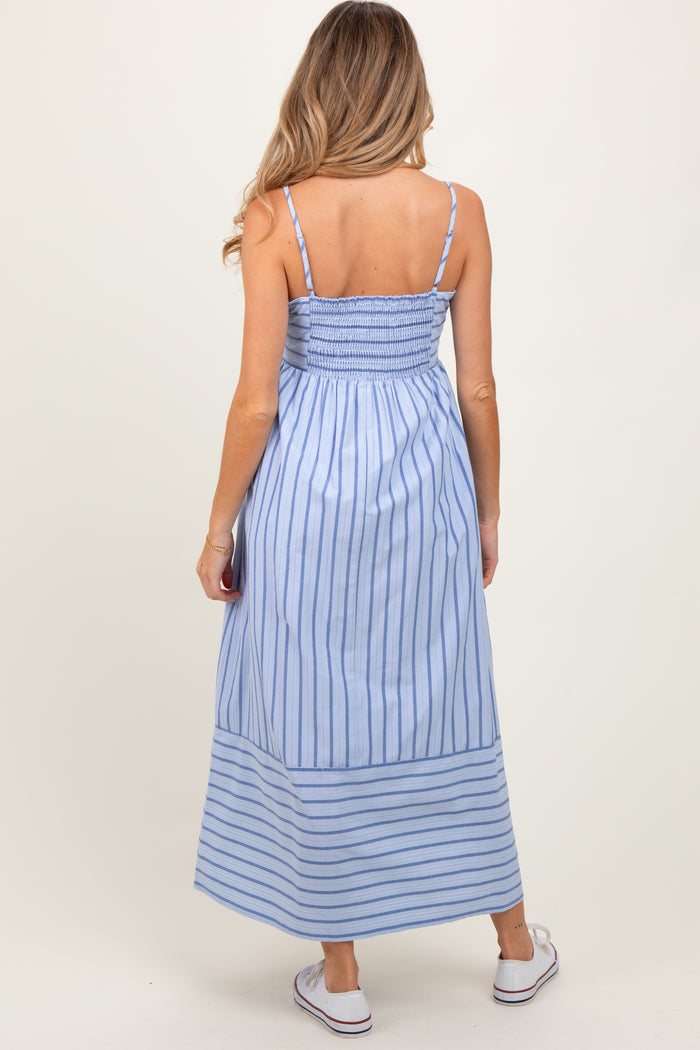 woman wearing a blue and white striped maternity maxi dress with a smocked back and adjustable straps