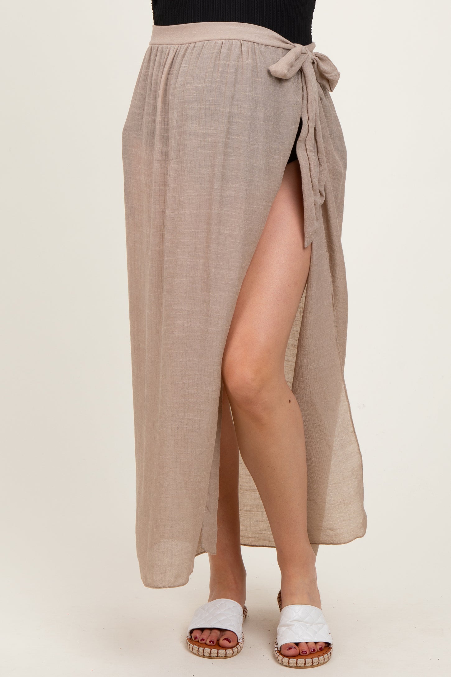 maternity wear beige wrap skirt with a side slit and tie detail, worn by a model