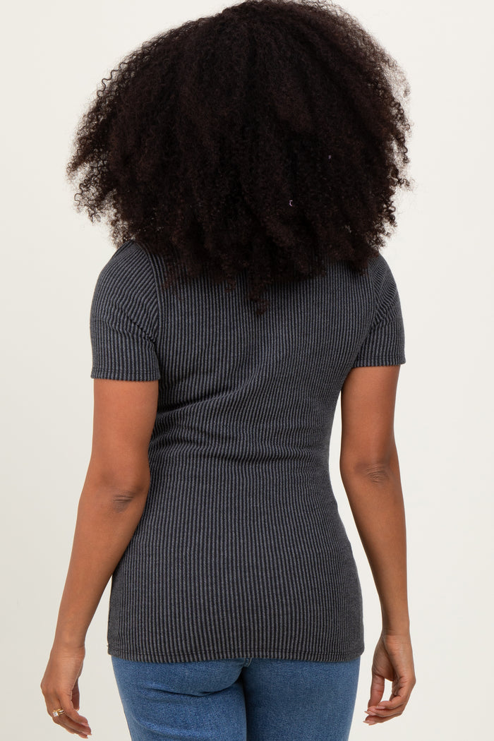 woman wearing a charcoal gray ribbed short sleeve top and blue jeans, seen from the back
