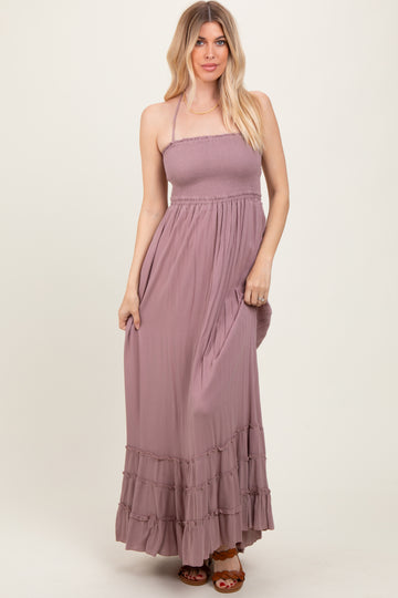 woman wearing a mauve strapless maxi dress with smocked bodice and ruffle hem